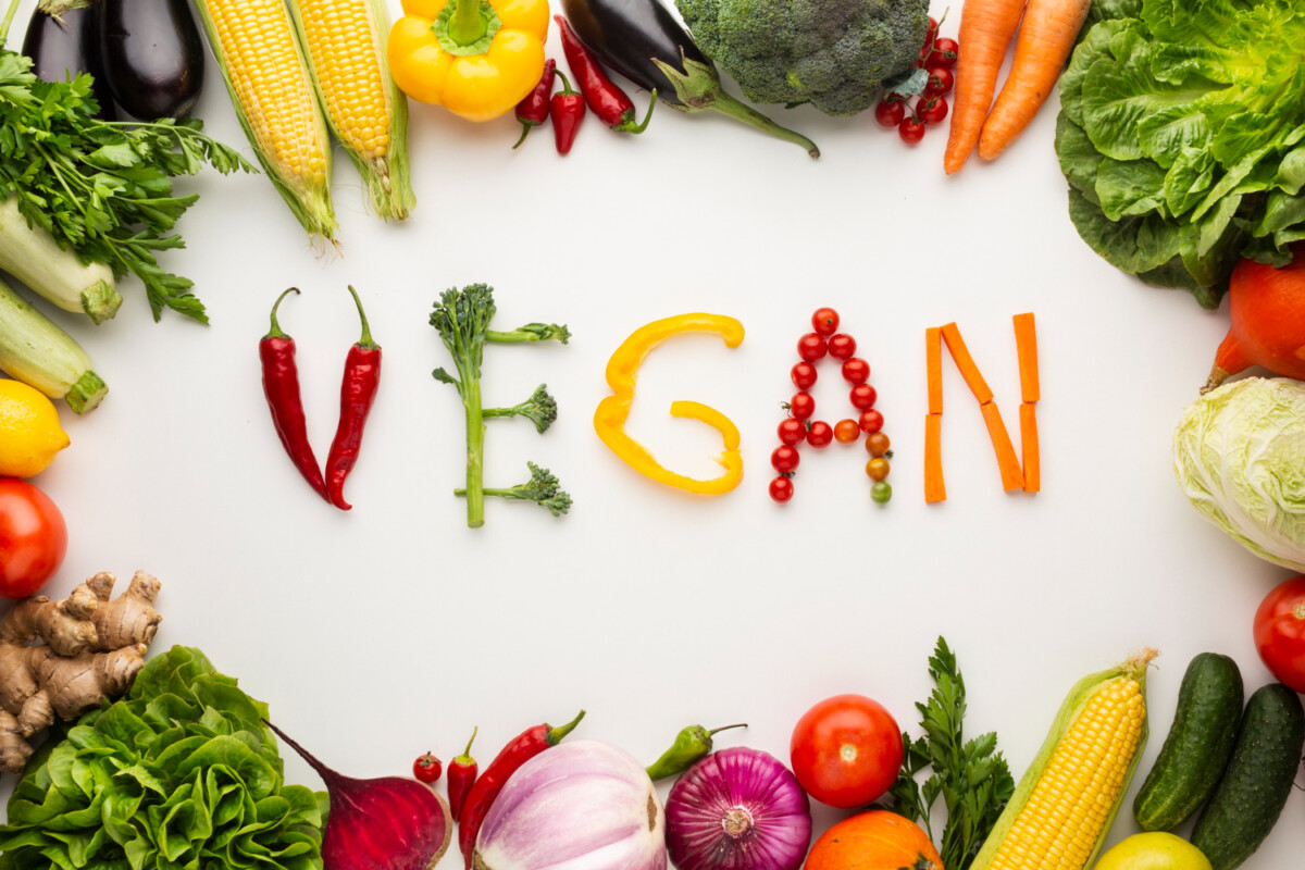 top-view-vegan-lettering-made-out-vegetables-white-background Wegańskie źródła białka. Sprawdź, jakie produkty wybierać! 